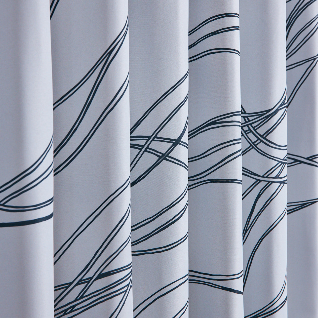 流れるような曲線が描かれた、モダンで動きのあるデザインが特徴のカーテン